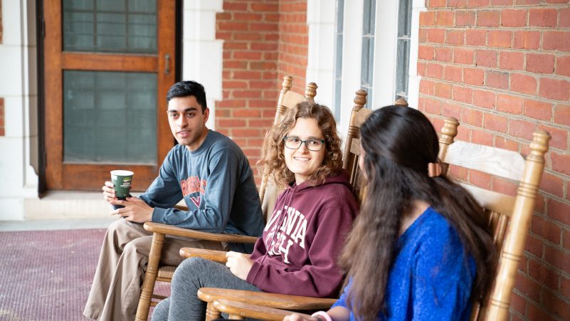 Students sitting on the porch at Hillcrest Hall