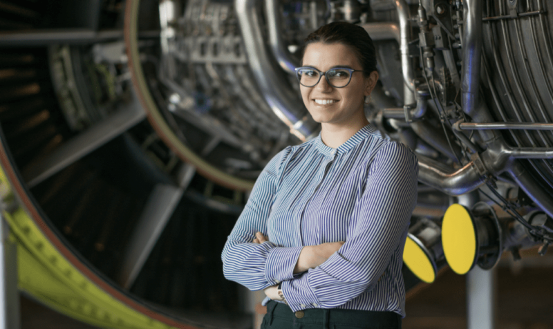 Picture of woman standing in front of GE aviation tech